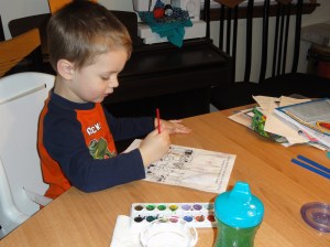 Boy painting watercolors